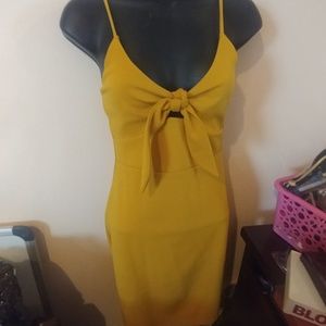 Yellow strappy dress with bow in front